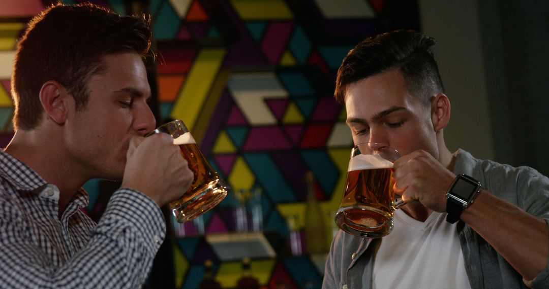 Friends Enjoying Beer at Vibrant Bar with Geometric Art