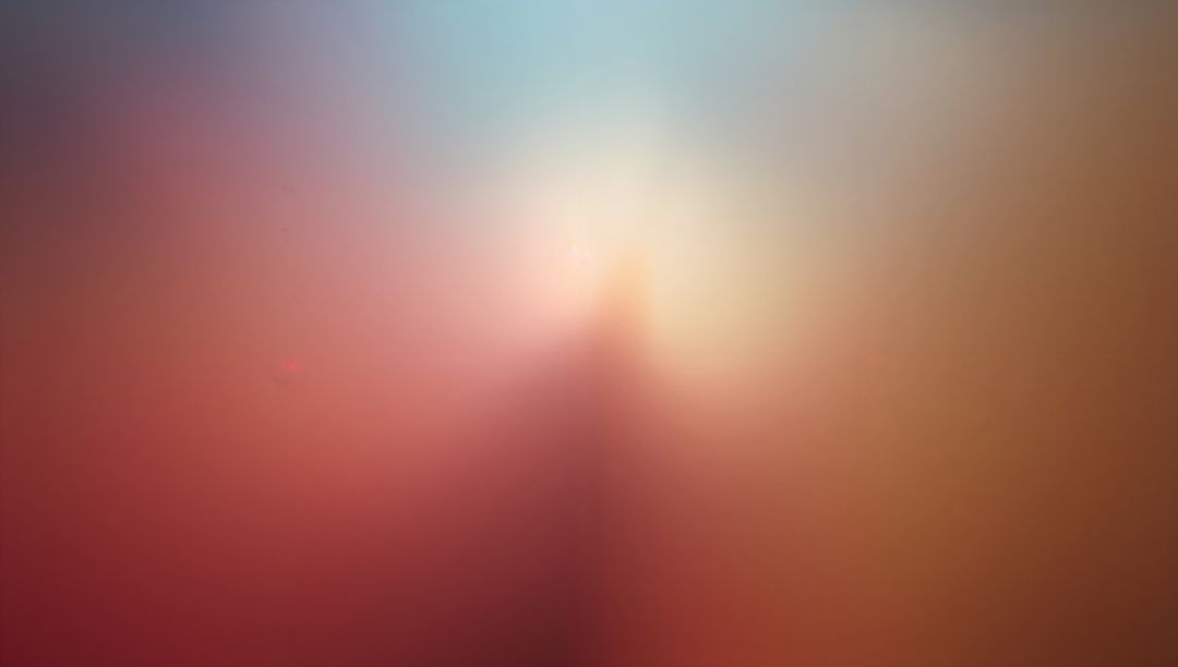 Soft-focus gradient with central glow and triangular blur in red-orange to blue tones