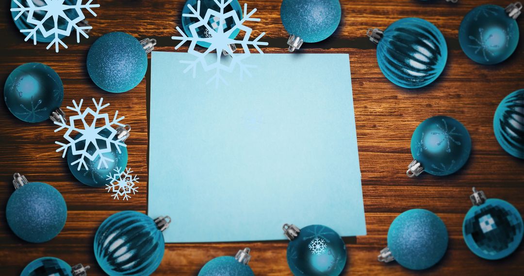 Festive Blue Christmas Baubles with Snowflakes Around Blank Paper