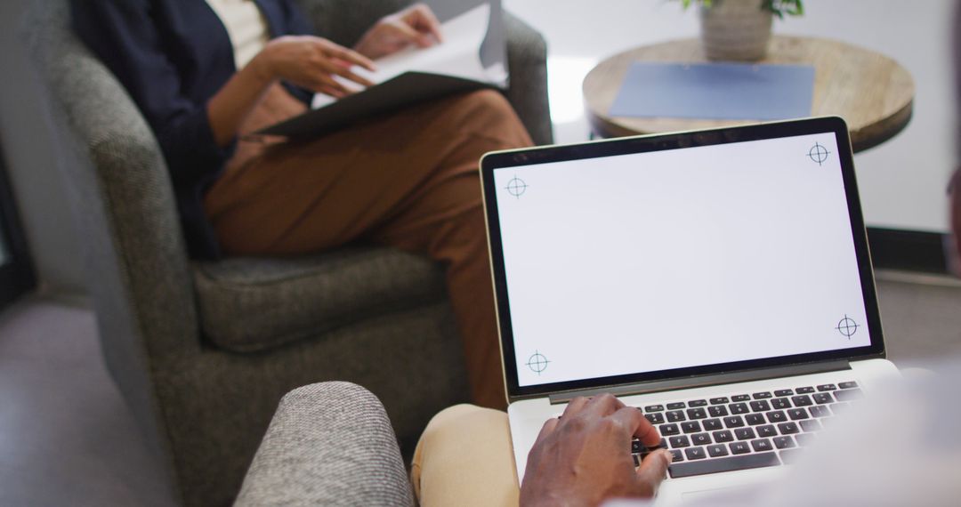 Collaborating in Modern Office with Open Laptop Screen