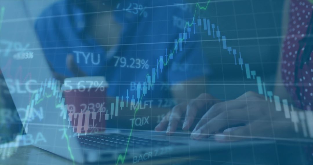 Colleagues Analyzing Financial Data on Laptop with Charts Overlay