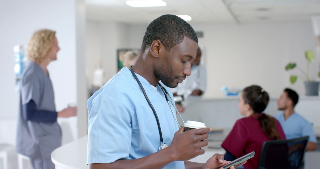 Male Nurse Checking Phone While Having Coffee in Hospital Break Room - Free Images, Stock Photos and Pictures on Pikwizard.com