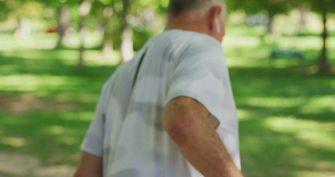 Senior Man Exercising Outdoors in Park with Wireless Earbuds - Free Images, Stock Photos and Pictures on Pikwizard.com