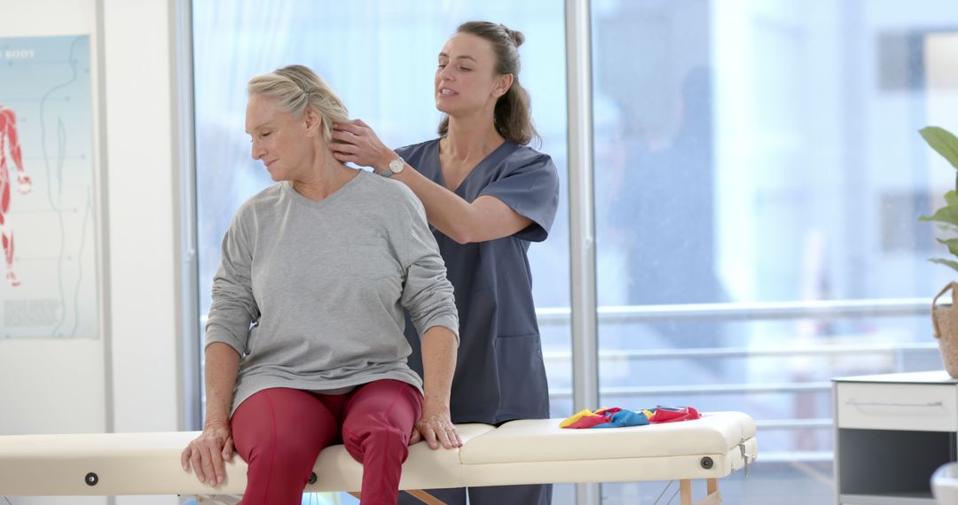 Female Physiotherapist Treating Elderly Patient with Neck Pain - Free Images, Stock Photos and Pictures on Pikwizard.com