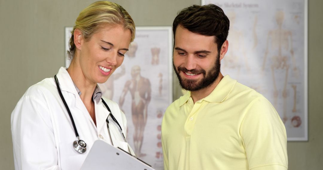 Doctor Discussing Health Report with Smiling Patient at Clinic - Free Images, Stock Photos and Pictures on Pikwizard.com