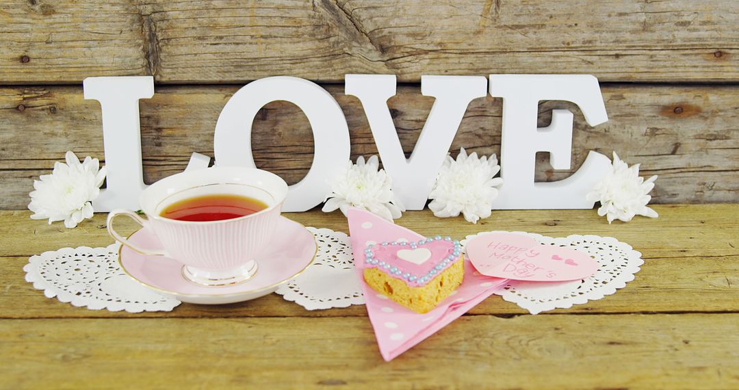 A Valentine's Day themed tea setting exudes romance with its LOVE sign and cozy decor. - Free Images, Stock Photos and Pictures on Pikwizard.com