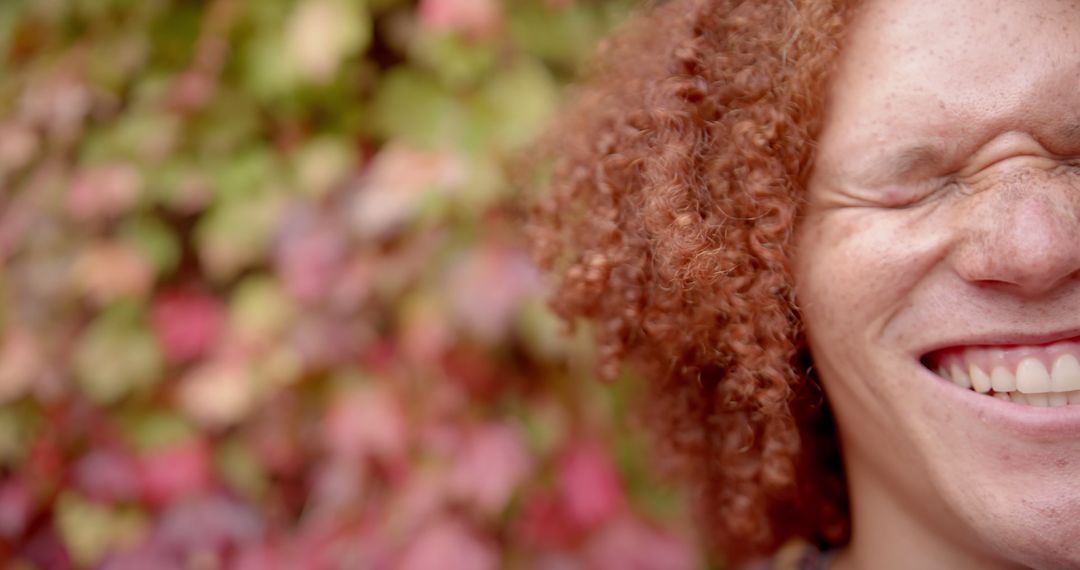 Close-up of Person with Red Curly Hair Smiling Joyfully - Free Images, Stock Photos and Pictures on Pikwizard.com