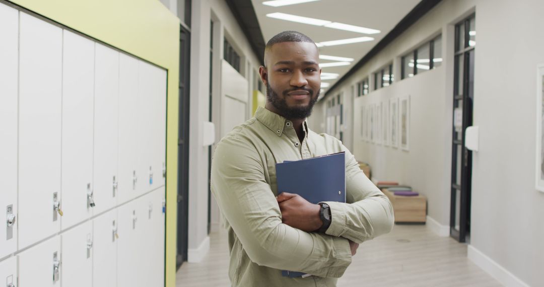 Image of happy african american male teacher standing in school hall - Free Images, Stock Photos and Pictures on Pikwizard.com