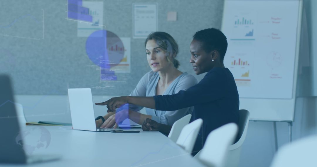 Collaborative Team Analyzing Data on Laptop in Modern Office