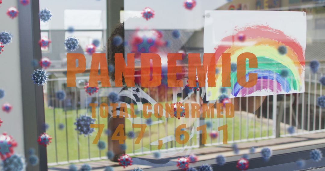 Pandemic Text Reflected in Child's Rainbow Art at Window