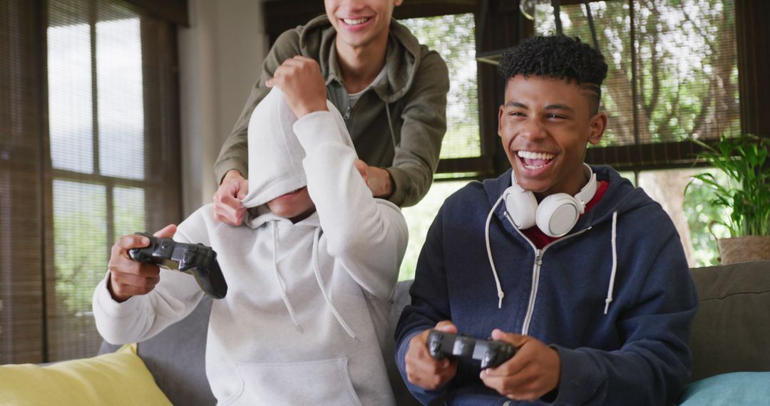 Diverse Teenage Friends Playing Video Games Laughing - Free Images, Stock Photos and Pictures on Pikwizard.com