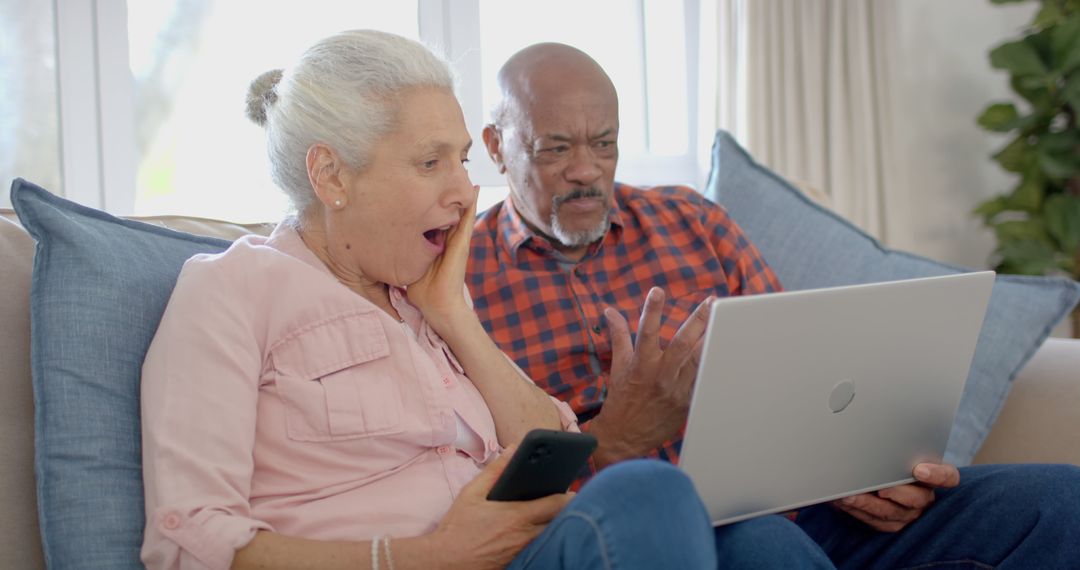 Surprised Senior Couple Engaging with Technology at Home