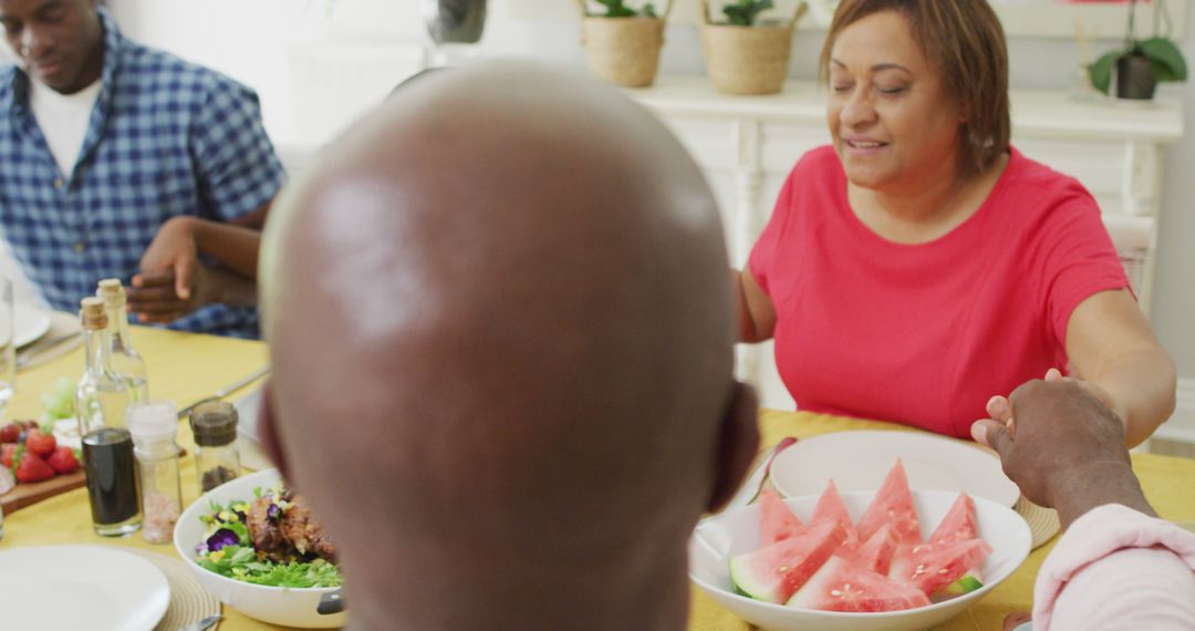 Image of african american family praying before meal at home - Free Images, Stock Photos and Pictures on Pikwizard.com