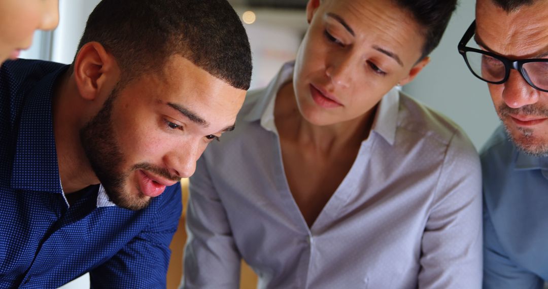 Diverse Team Collaborating on Documents in Office
