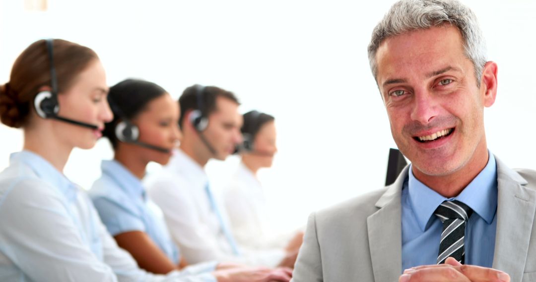 Smiling Call Center Manager with Team at Work - Free Images, Stock Photos and Pictures on Pikwizard.com