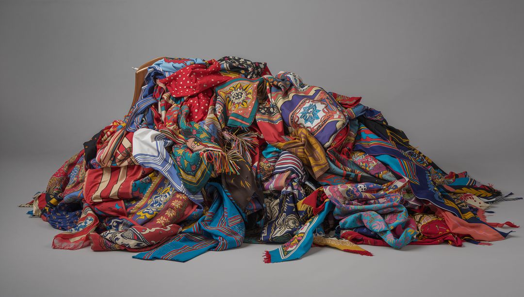 Vibrant Patterned Silk Scarves Draping in Colorful Pile with Tassels and Fringe