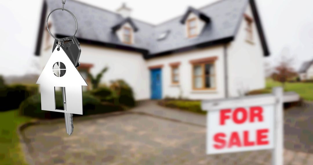 Keys with House Fob in Front of Home with For Sale Sign