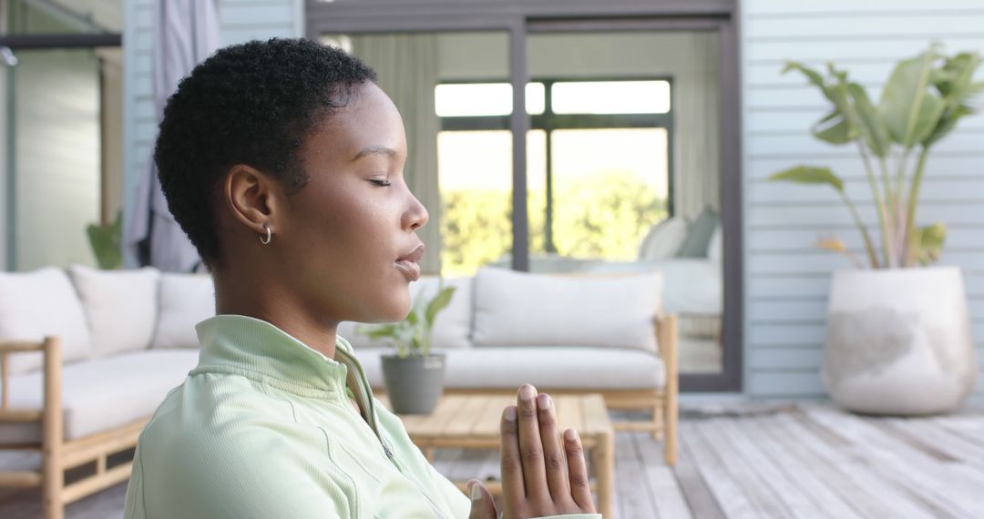 Woman Meditating Peacefully Outdoors on Wooden Deck - Free Images, Stock Photos and Pictures on Pikwizard.com