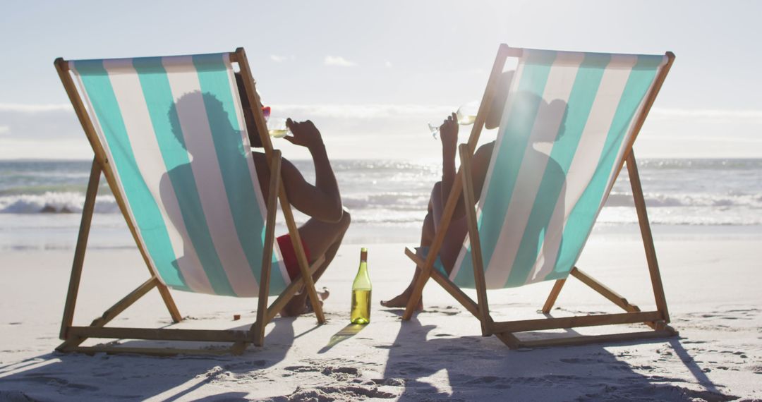 Couple Relaxing on Beach Chairs Drinking Champagne at Sunset - Free Images, Stock Photos and Pictures on Pikwizard.com