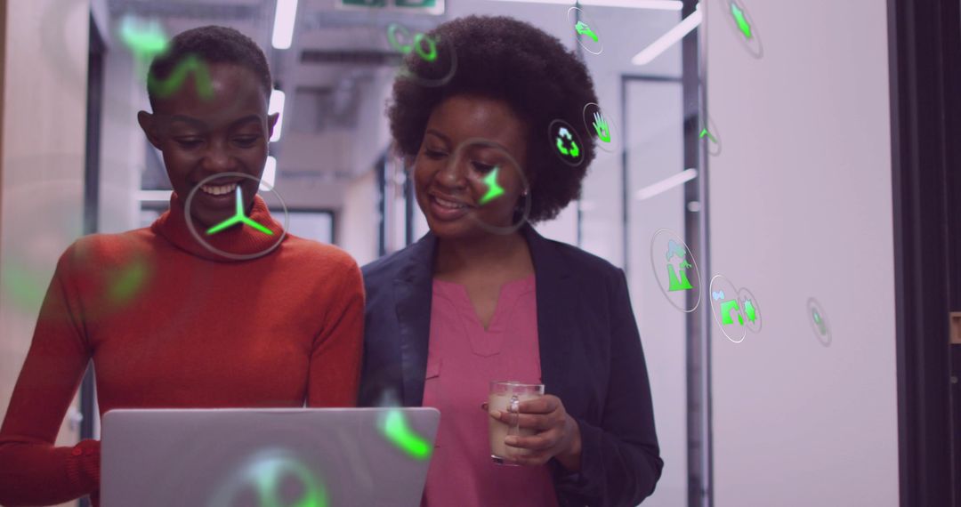 Colleagues Examining Laptop with AR Icons in Modern Office Environment