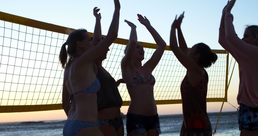 Group of Women Playing Beach Volleyball at Sunset - Free Images, Stock Photos and Pictures on Pikwizard.com