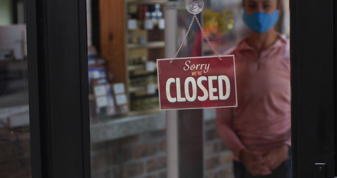 Store Closed Sign with Person Wearing Face Mask in Background - Free Images, Stock Photos and Pictures on Pikwizard.com