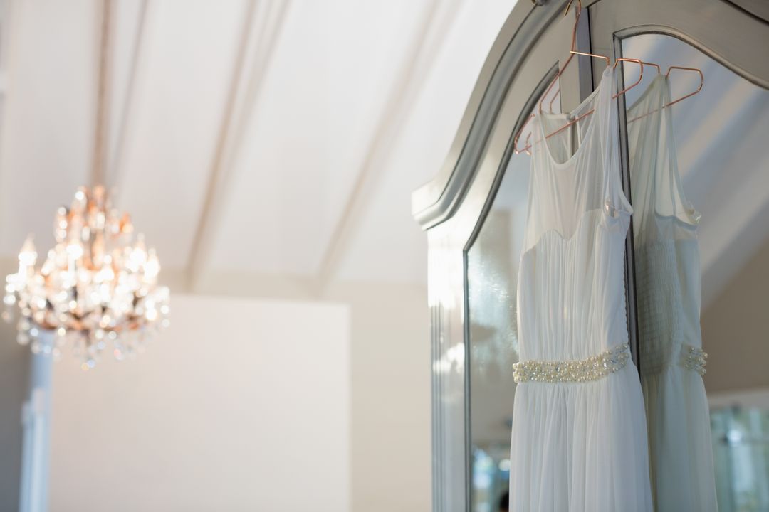 Elegant Wedding Dress Hanging on Mirror - Free Images, Stock Photos and Pictures on Pikwizard.com
