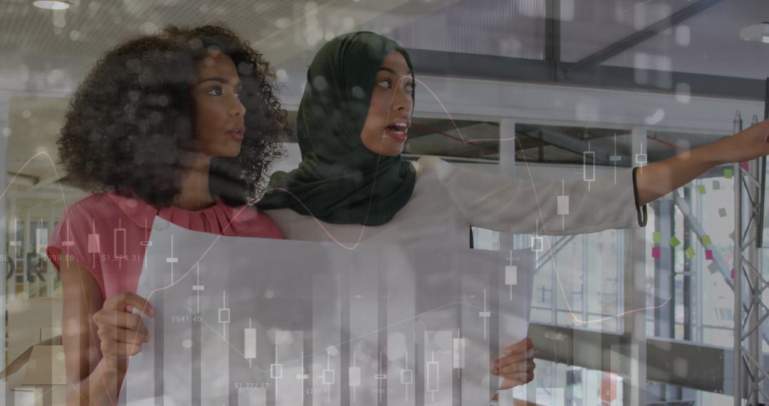 Two Female Creative Professionals Analyzing Data Visualizations