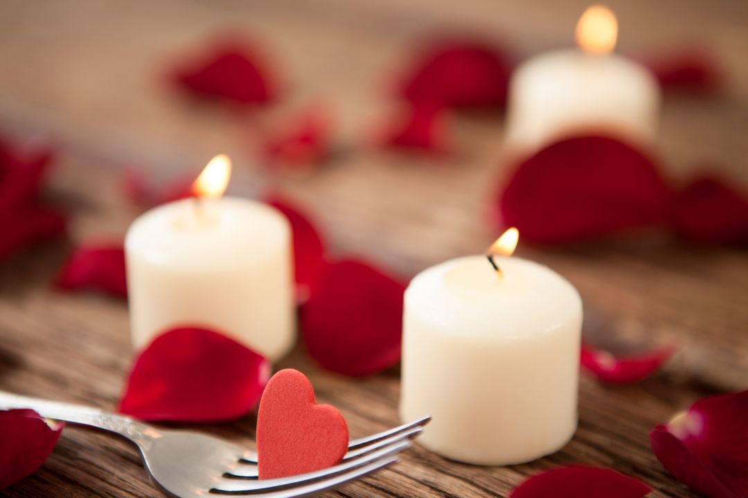 Romantic Candlelight with Rose Petals on Wooden Table - Free Images, Stock Photos and Pictures on Pikwizard.com
