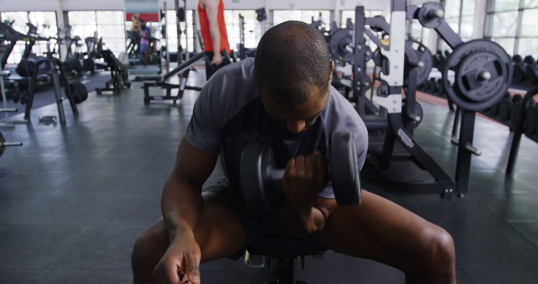 Muscular Man Doing Bicep Curl Exercise at Fitness Gym - Free Images, Stock Photos and Pictures on Pikwizard.com