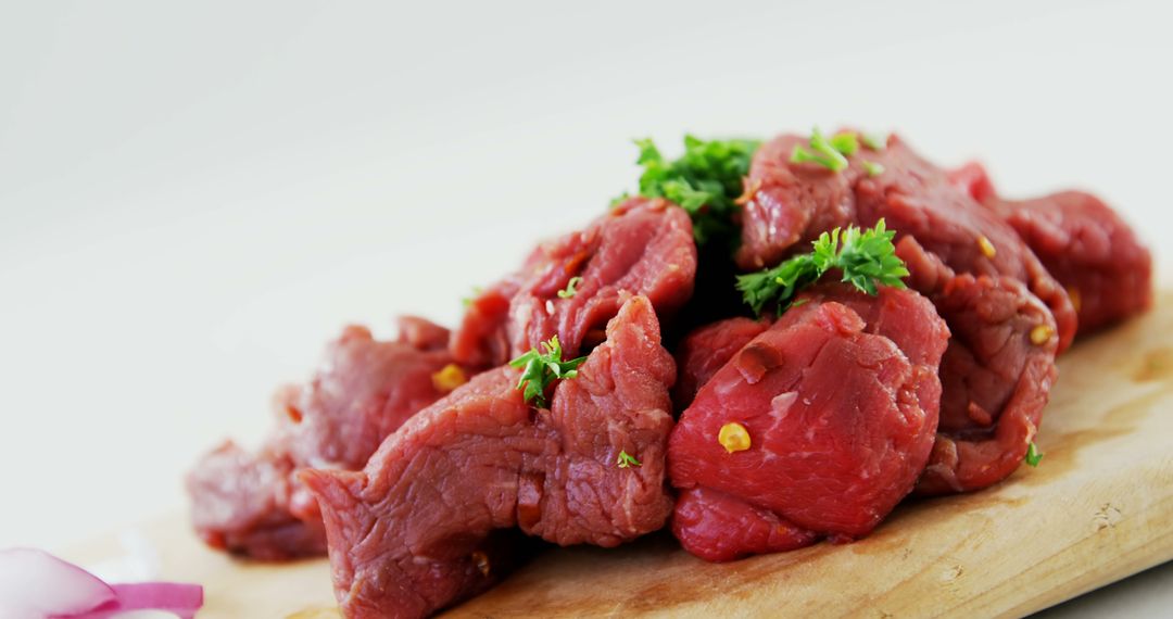 Fresh Raw Beef Cubes with Garnish on Wooden Cutting Board - Free Images, Stock Photos and Pictures on Pikwizard.com