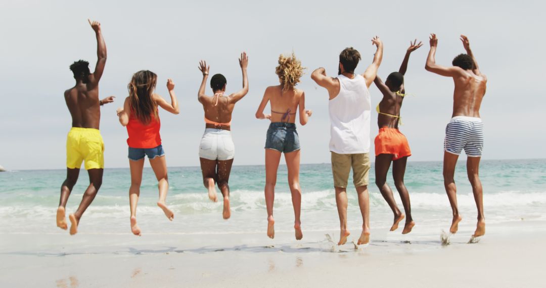 Joyful Diverse Friends Jumping at Beach in Summer