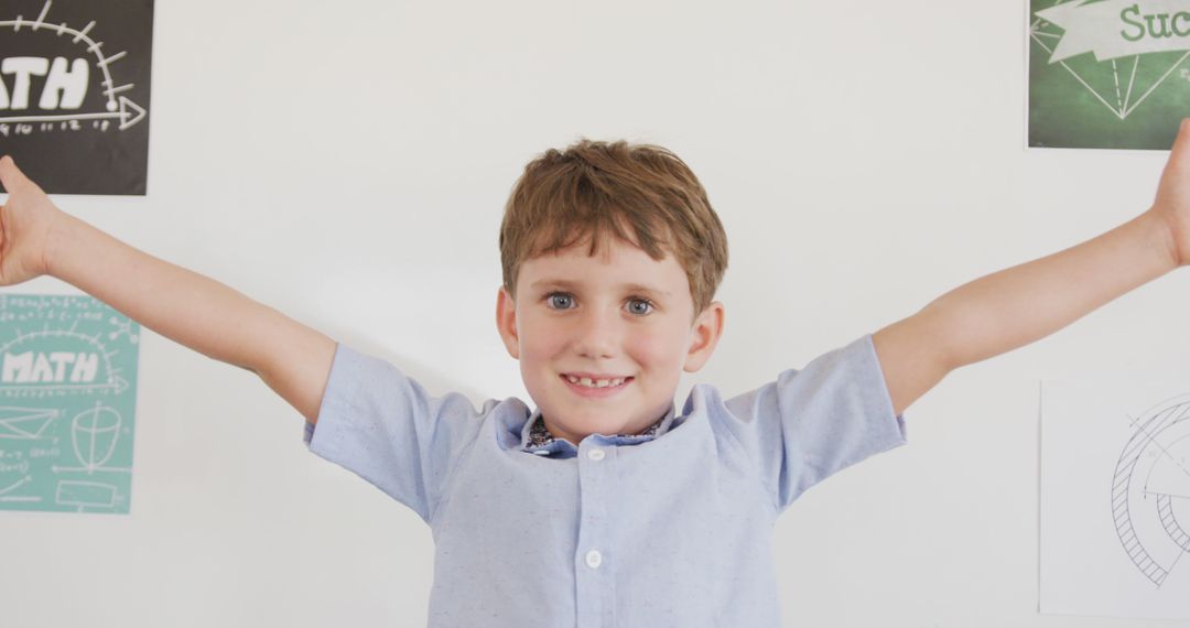 Joyful Young Boy with Open Arms and Happy Smile in Classroom - Free Images, Stock Photos and Pictures on Pikwizard.com