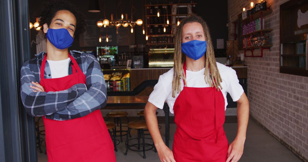 Baristas wearing face masks and red aprons in cafe - Free Images, Stock Photos and Pictures on Pikwizard.com