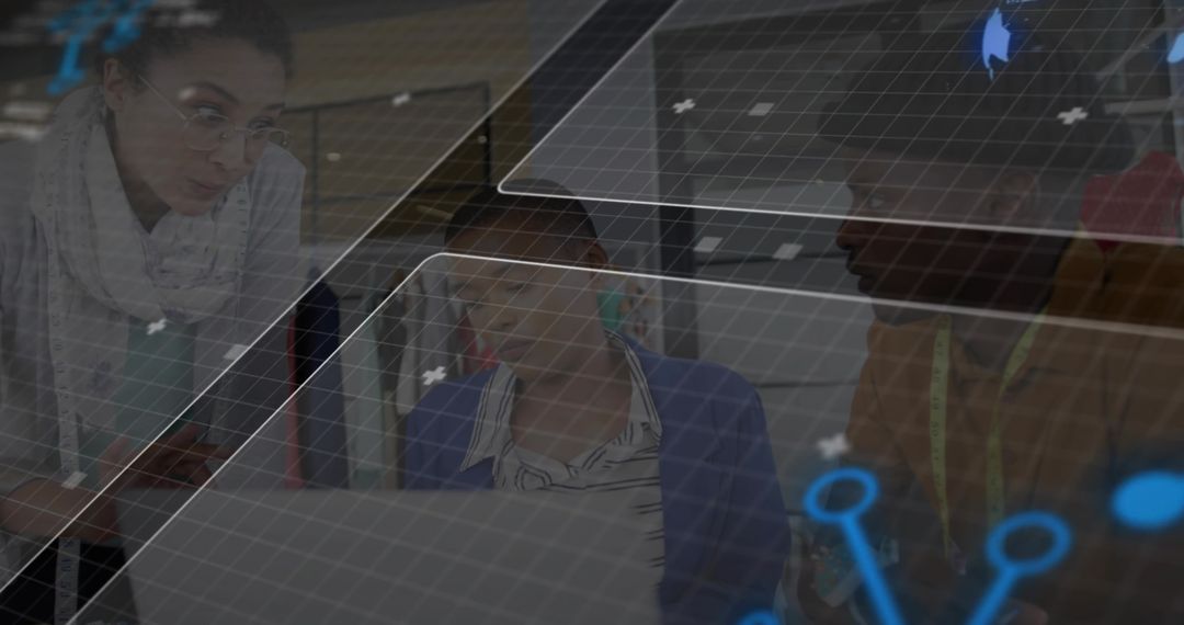 Fashion designers reviewing tech-driven garment designs on laptop with holographic grid