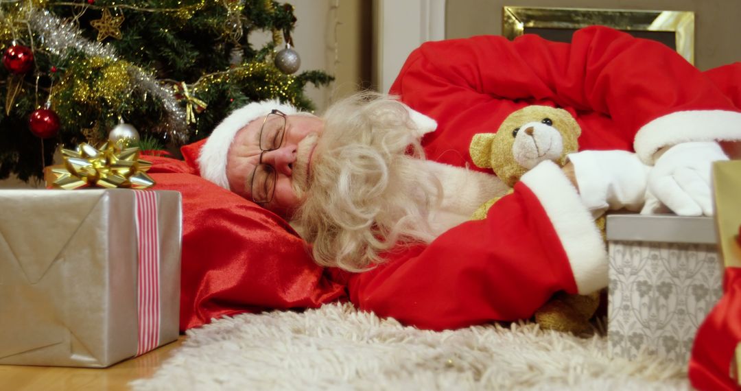 Santa impersonator rests with teddy bear amid holiday bustle. - Free Images, Stock Photos and Pictures on Pikwizard.com