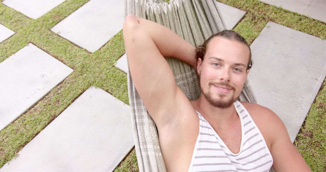 Man with Beard Relaxing on Garden Hammock in Summer