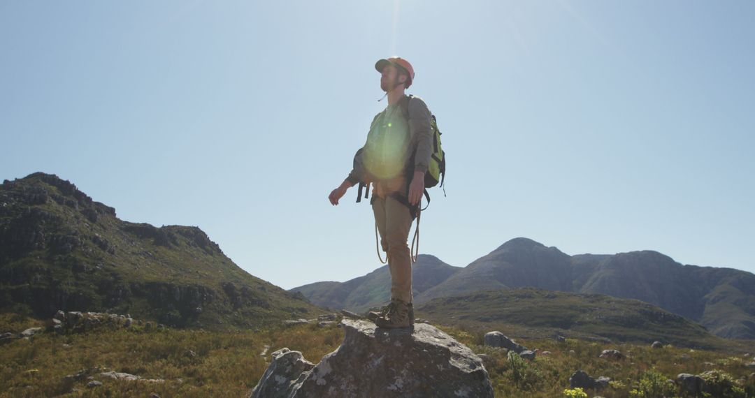 Hiker on a Rock Enjoying Scenic Mountain View at Sunrise - Free Images, Stock Photos and Pictures on Pikwizard.com