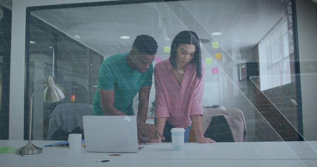 Focused Colleagues Analyzing Documents in Modern Office Space