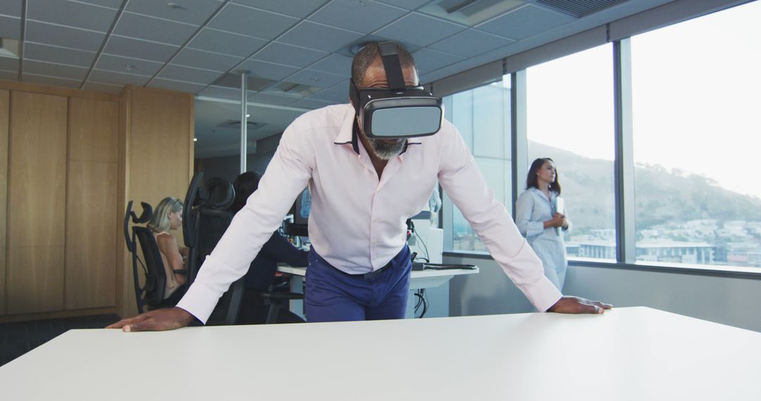 Businessman Exploring Virtual Reality in Modern Office Space - Free Images, Stock Photos and Pictures on Pikwizard.com