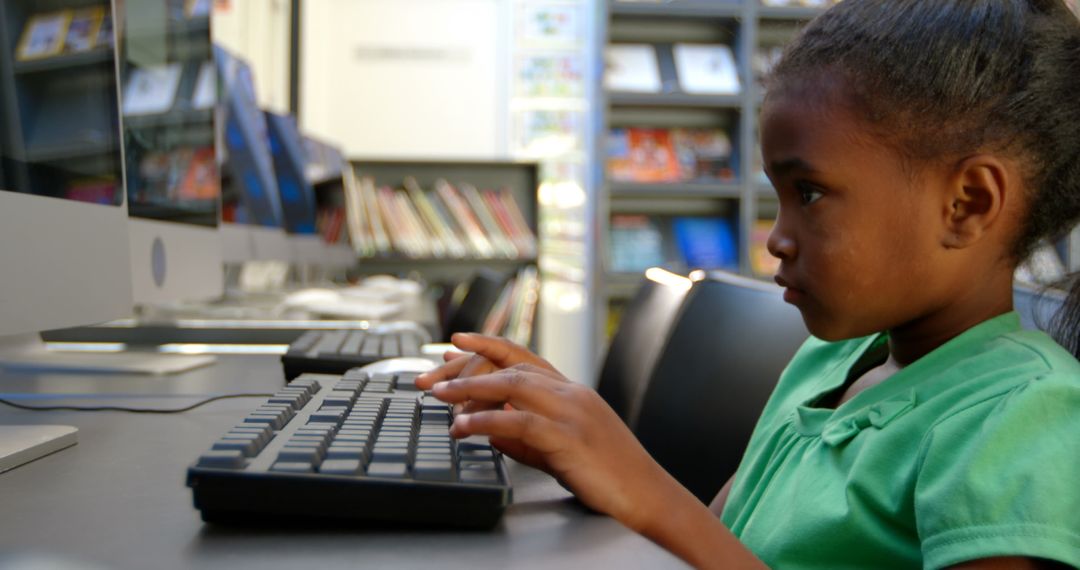 Focused Schoolgirl Using Computer in Library Environment