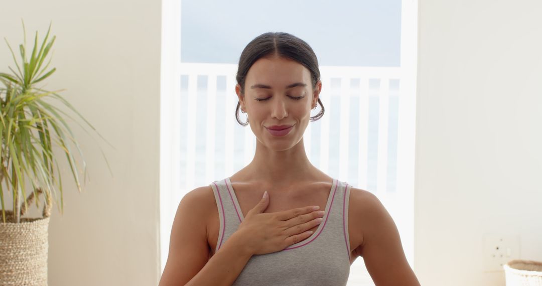 Woman Practicing Mindfulness at Home Near Open Balcony