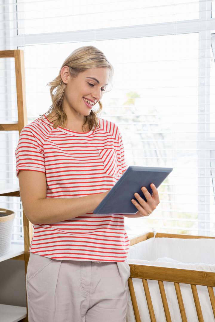 Smiling Woman Using Tablet at Home - Free Images, Stock Photos and Pictures on Pikwizard.com