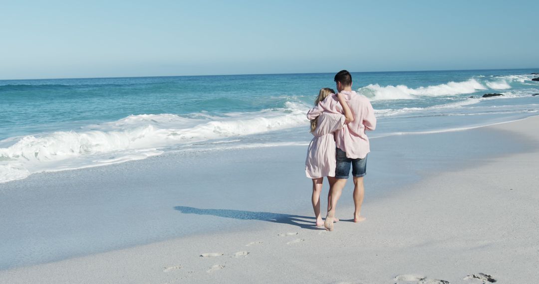 Couple Walking Along Beach on a Sunny Day - Free Images, Stock Photos and Pictures on Pikwizard.com