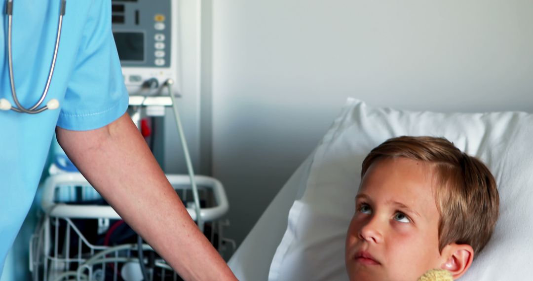 Doctor Consoling Young Boy on Hospital Bed - Free Images, Stock Photos and Pictures on Pikwizard.com