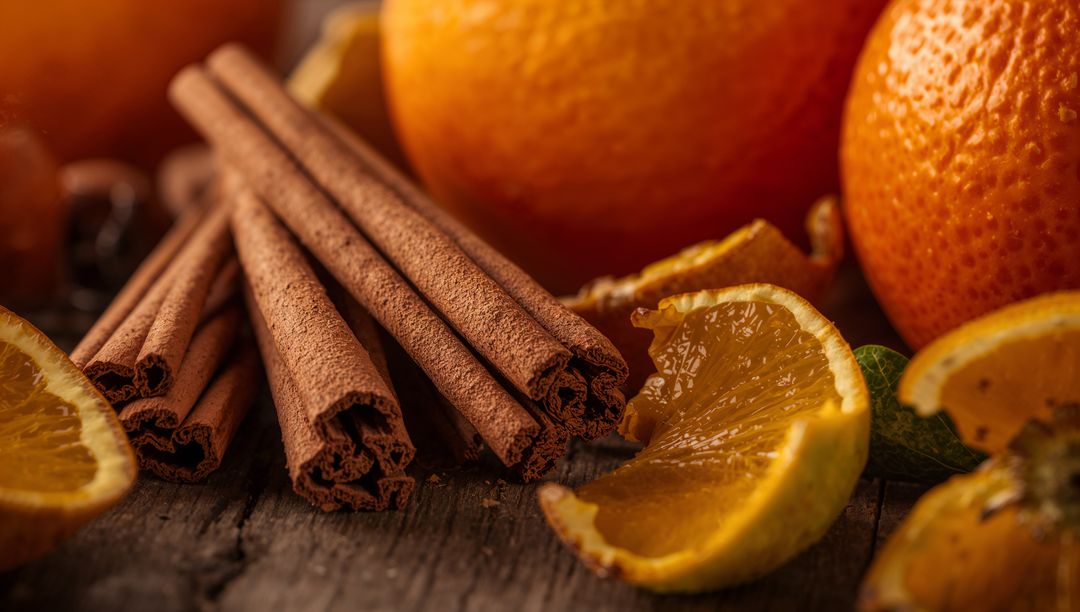 Rustic cinnamon sticks with orange wedges creating warm festive citrus spice still life