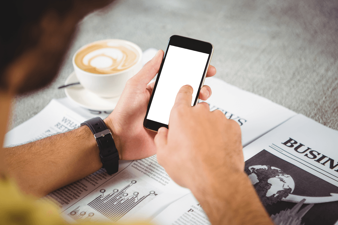 Hands Holding Transparent Phone Over Business Newspaper