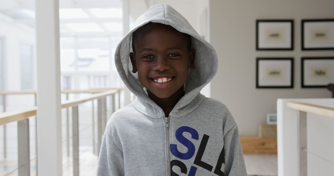 Portrait of happy african american boy wearing hoodie smiling at home - Free Images, Stock Photos and Pictures on Pikwizard.com