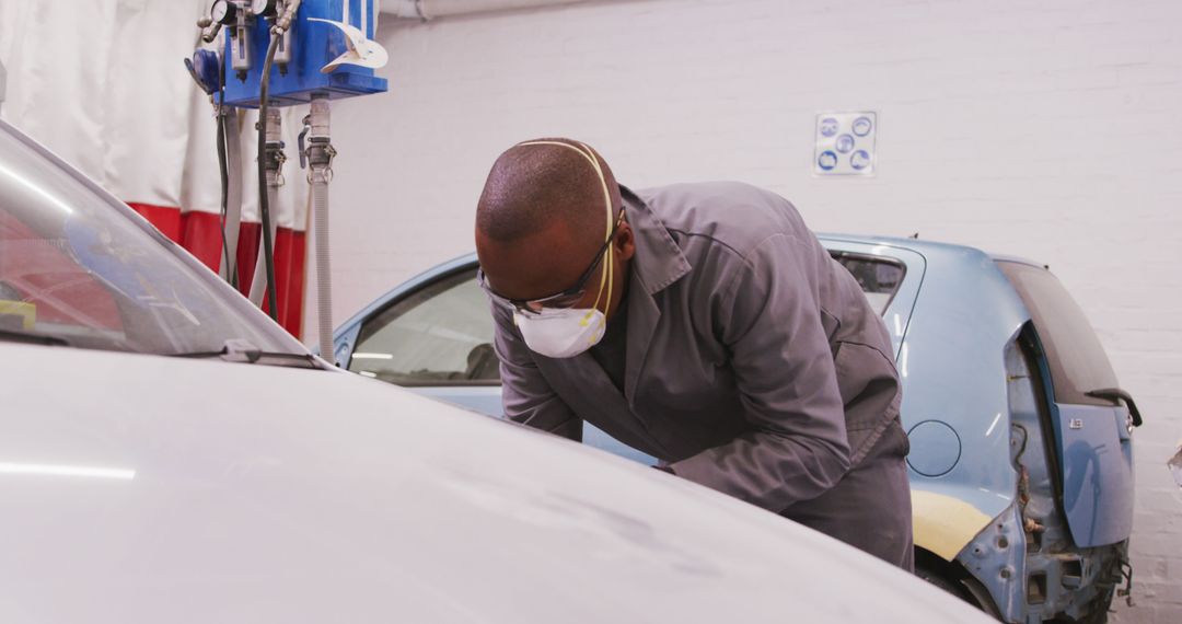 Automotive Repair Technician Inspecting Vehicle in Workshop - Free Images, Stock Photos and Pictures on Pikwizard.com