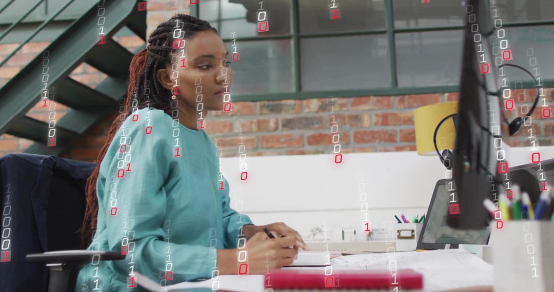 Woman Reviewing Papers at Modern Office Desk with Laptop and Binary Code Overlay
